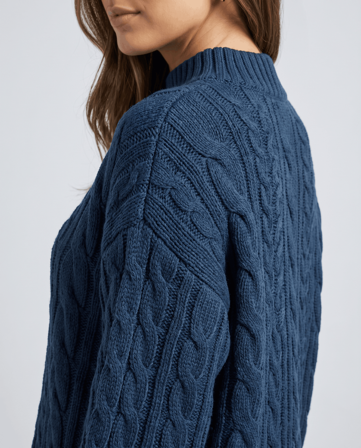 Blue Cable Knit Sweater worn by a female model from the side, highlighting the textured cable knit pattern, relaxed oversized fit, and balloon sleeve.