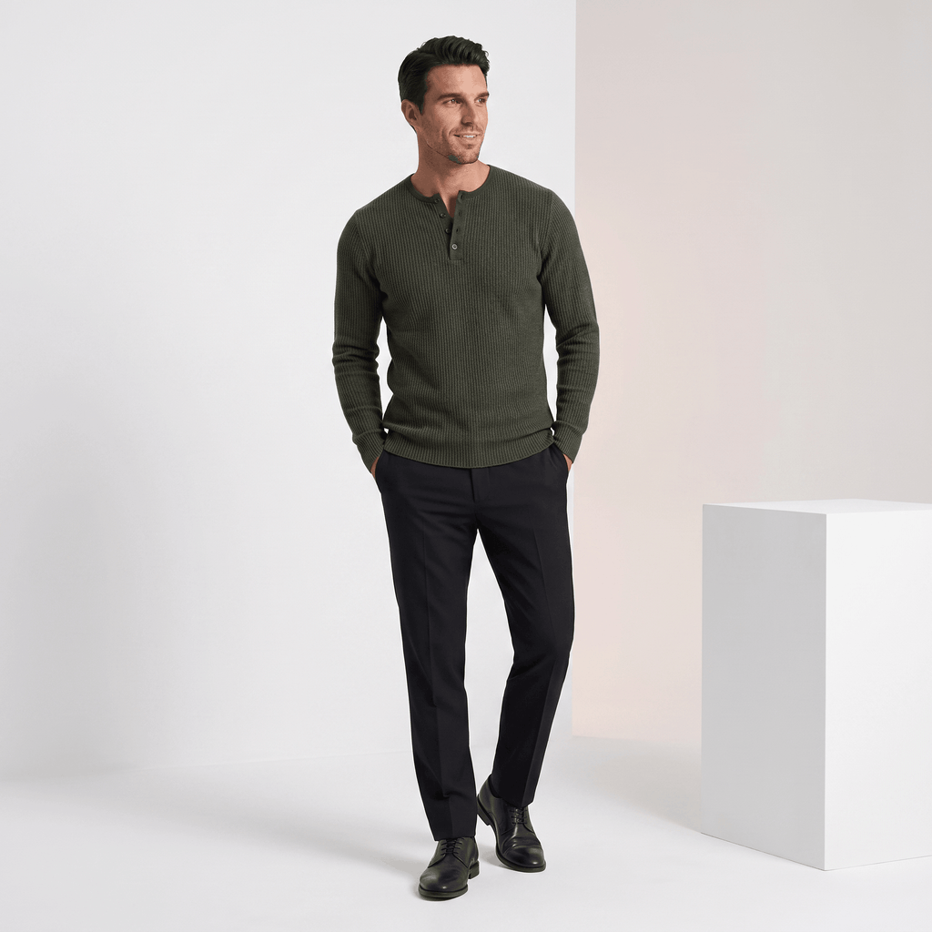 Olive green ribbed knit henley sweater with a four-button placket, styled in a regular fit with black trousers.