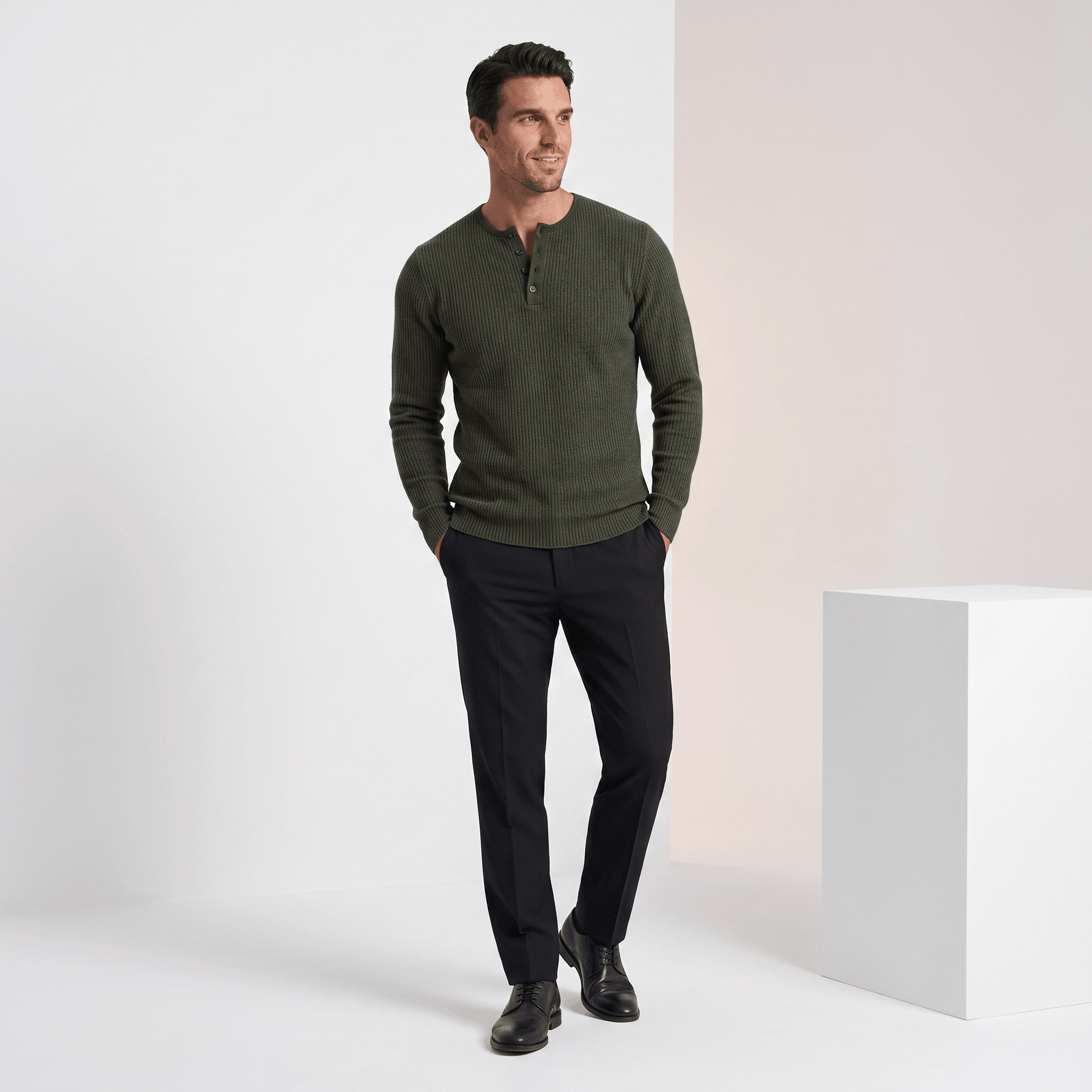 Olive green ribbed knit henley sweater with a four-button placket, styled in a regular fit with black trousers.