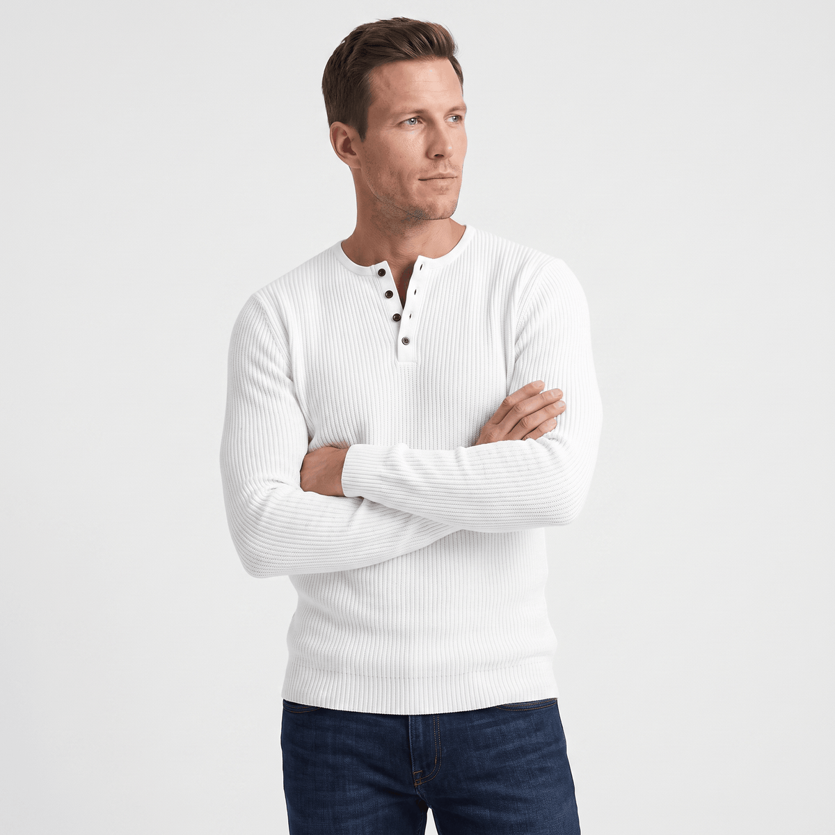 White ribbed knit henley sweater with a four-button placket, featuring a regular fit and long sleeves.
