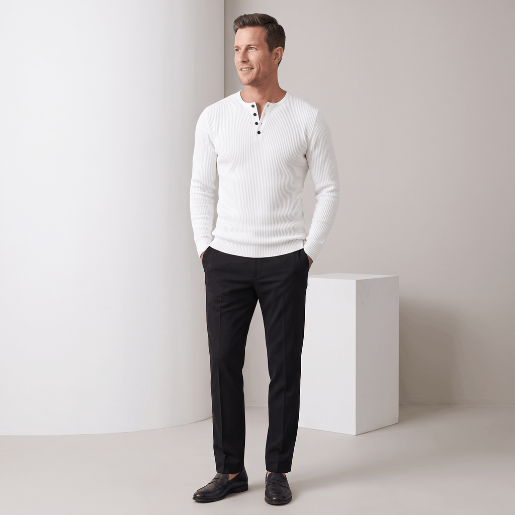 White ribbed knit henley sweater with a four-button placket, worn in a regular fit with black trousers.