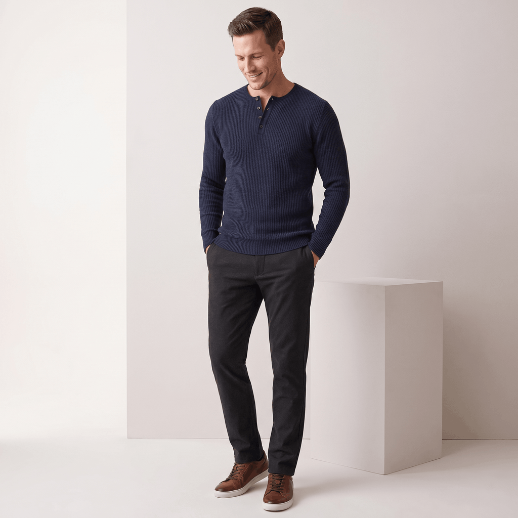 Navy blue ribbed knit henley sweater with a four-button placket, styled in a regular fit with dark trousers.