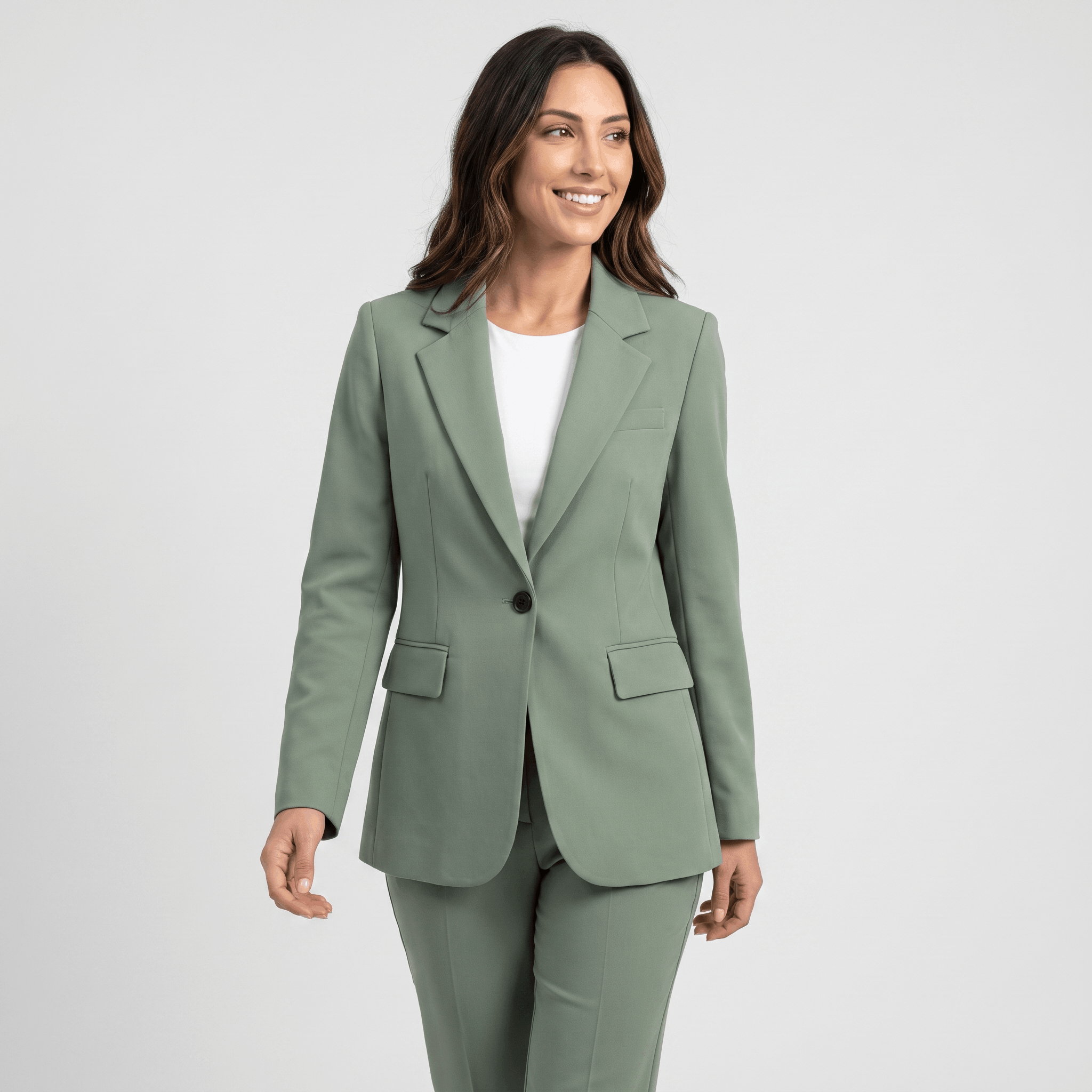 Female model wearing a sage green tailored blazer with notched lapels and a single-button closure.