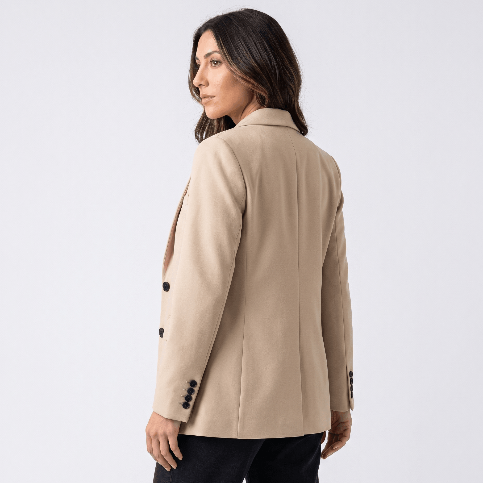 Female model wearing the ivory blazer, showing the back and fitted silhouette.