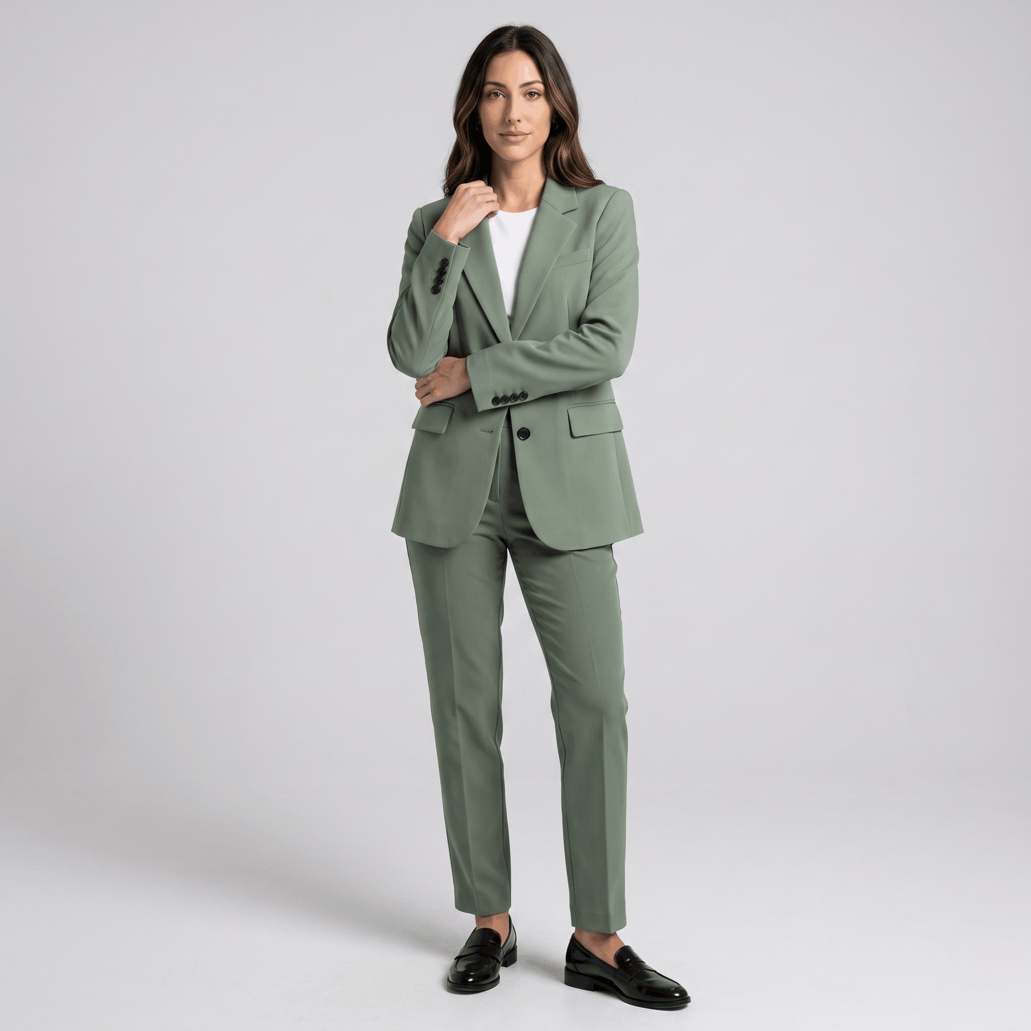 Female model wearing the sage green blazer with matching trousers and black heels.
