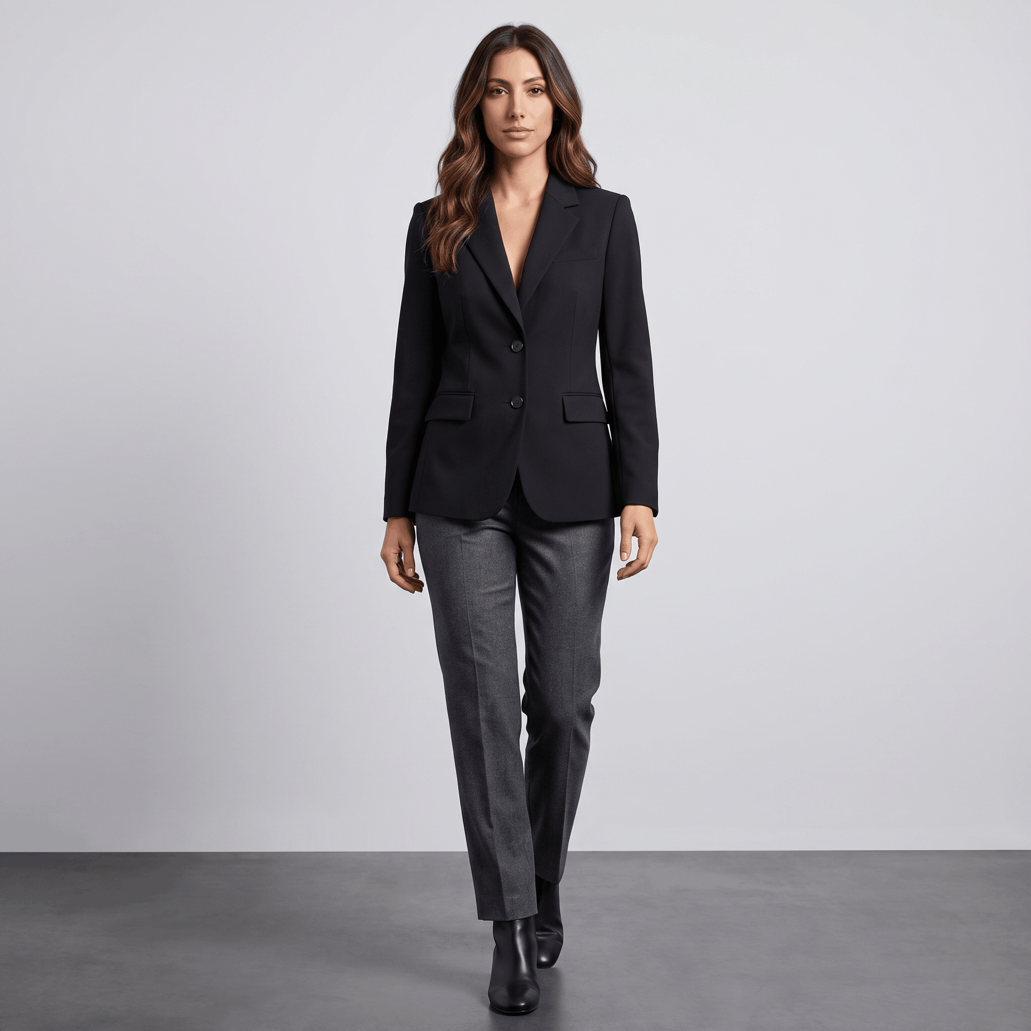 Female model wearing the black blazer with black trousers and boots.