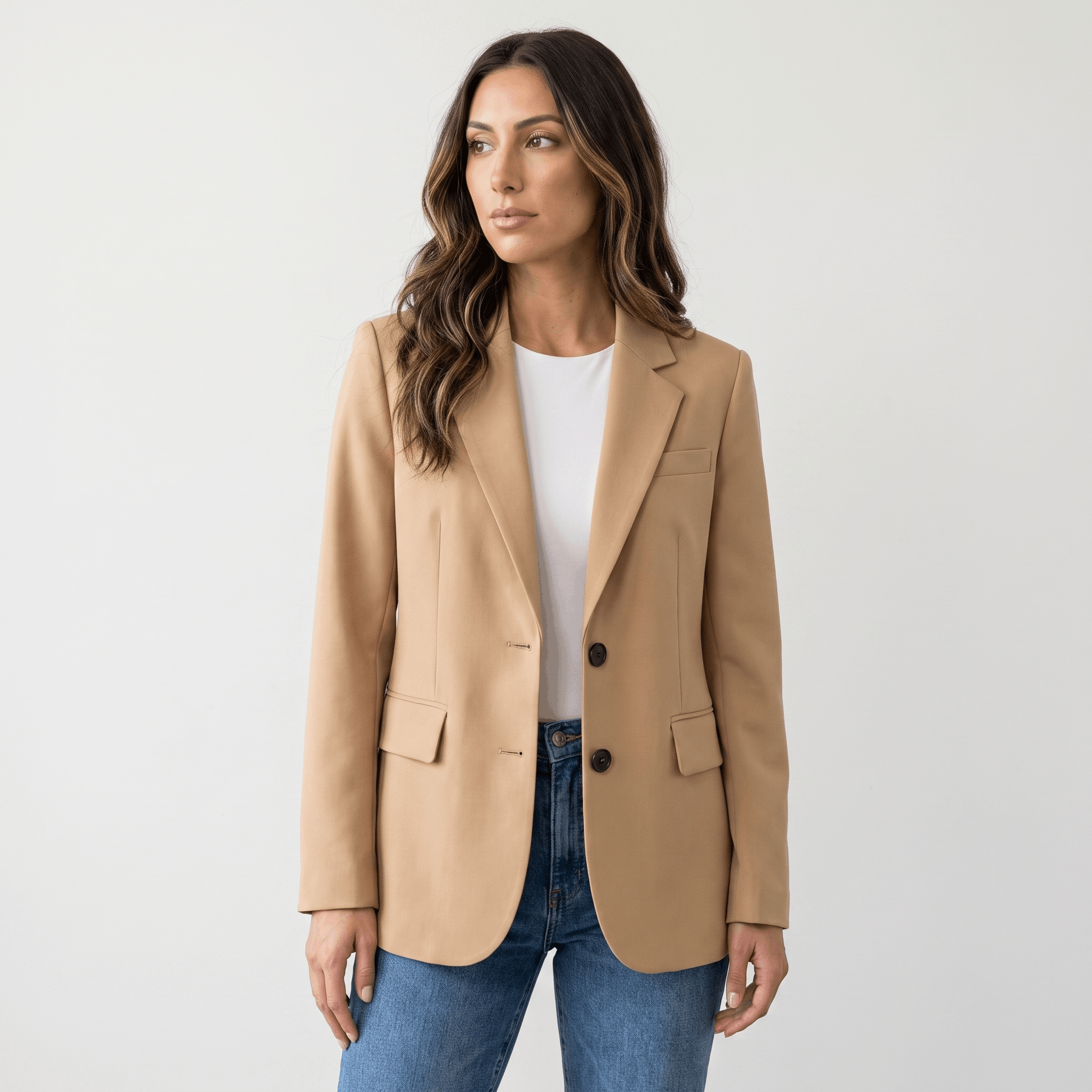 Female model wearing the beige blazer over a white top with blue jeans.