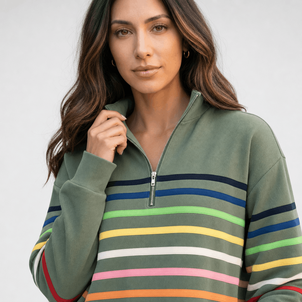 Close-up of the female model wearing the sage green multicolored striped quarter-zip sweater.