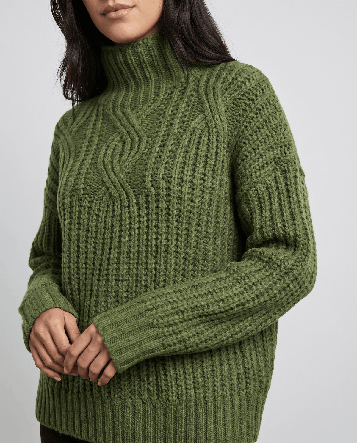 Green Chunky Cable Knit Sweater worn by a female model, featuring a mock neck, relaxed fit, chunky cable knit texture, and long sleeves.