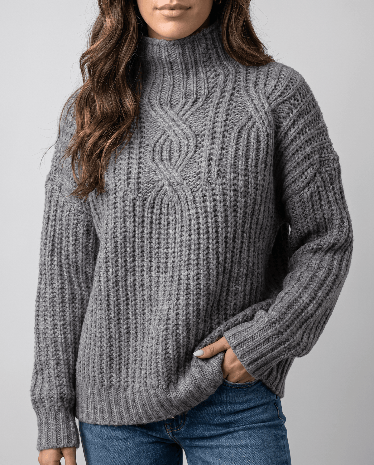 Gray Chunky Cable Knit Sweater worn by a female model with blue jeans, featuring a mock neck, relaxed fit, chunky cable knit texture, and long sleeves.