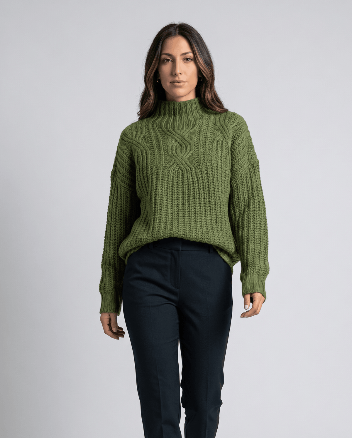 Green Chunky Cable Knit Sweater worn by a female model with dark pants, featuring a mock neck, relaxed fit, chunky cable knit texture, and long sleeves.