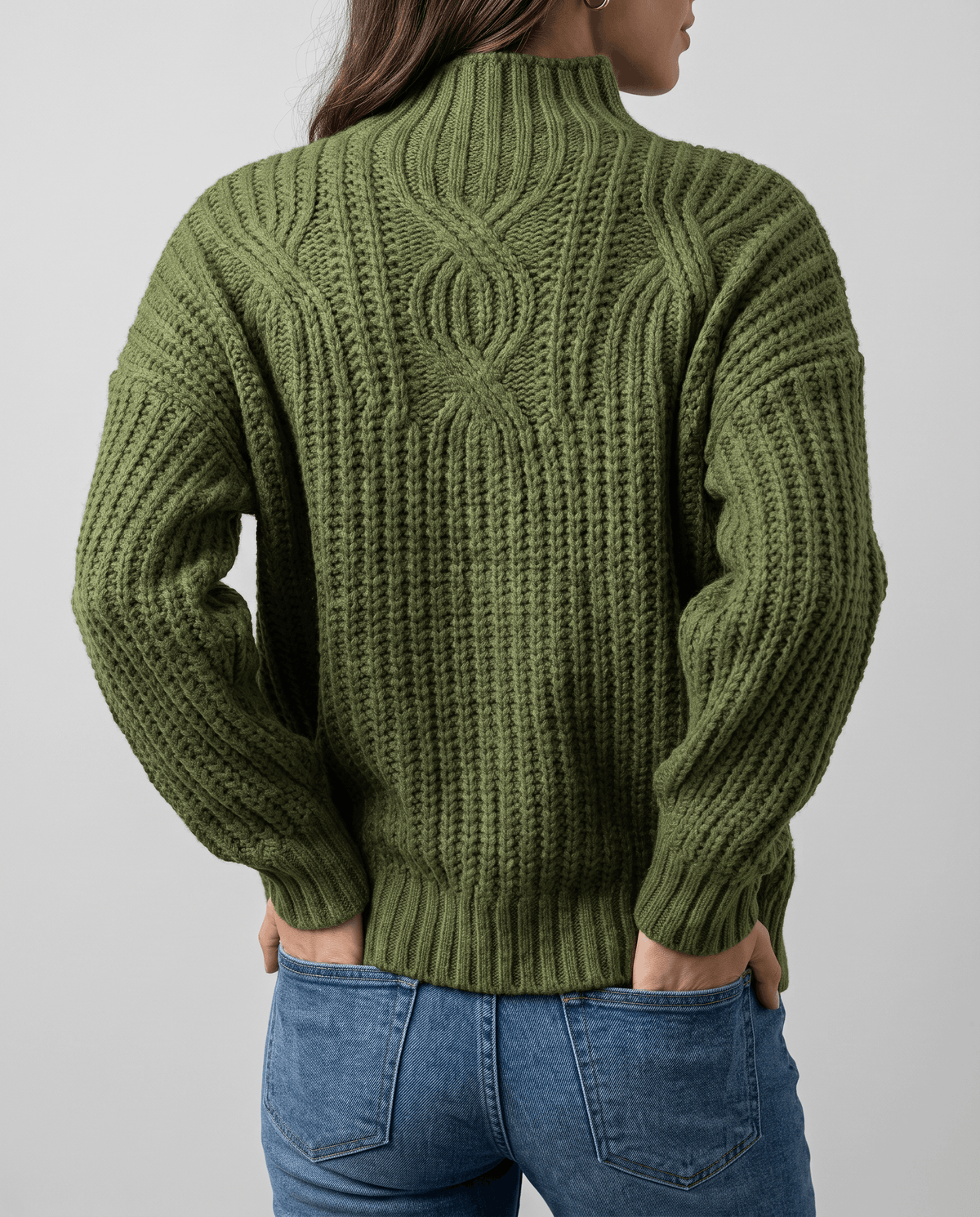 Green Chunky Cable Knit Sweater worn by a female model from the back, showcasing the chunky cable knit pattern, mock neck, relaxed fit, and ribbed hem.