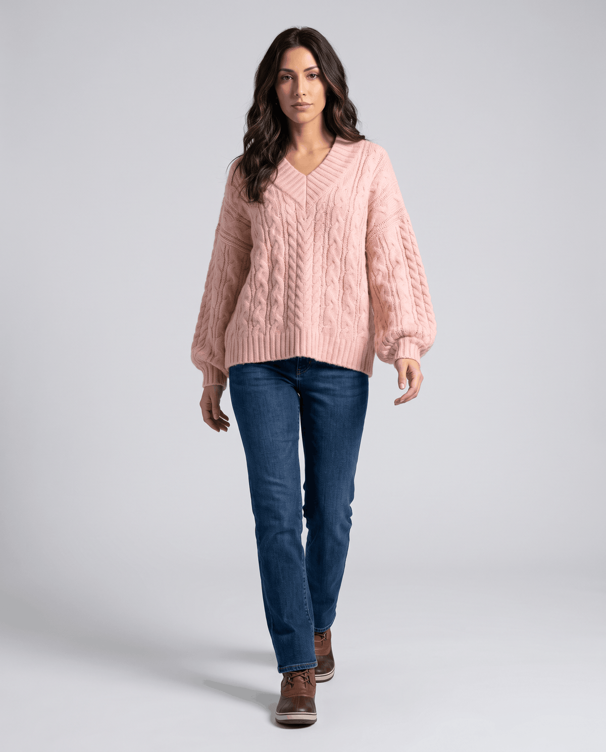 Pink Chunky Cable Knit Sweater worn by a female model with blue jeans, featuring an oversized fit, textured cable knit pattern, long sleeves, and relaxed silhouette.