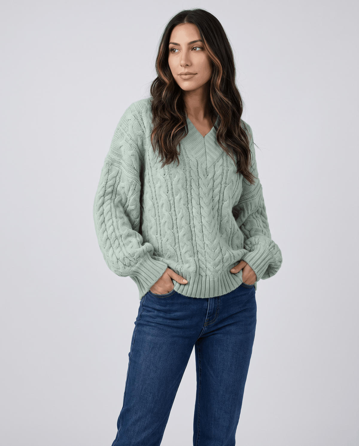Light green Chunky Cable Knit Sweater worn by a female model with blue jeans, featuring an oversized fit, textured cable knit pattern, long sleeves, and relaxed silhouette.