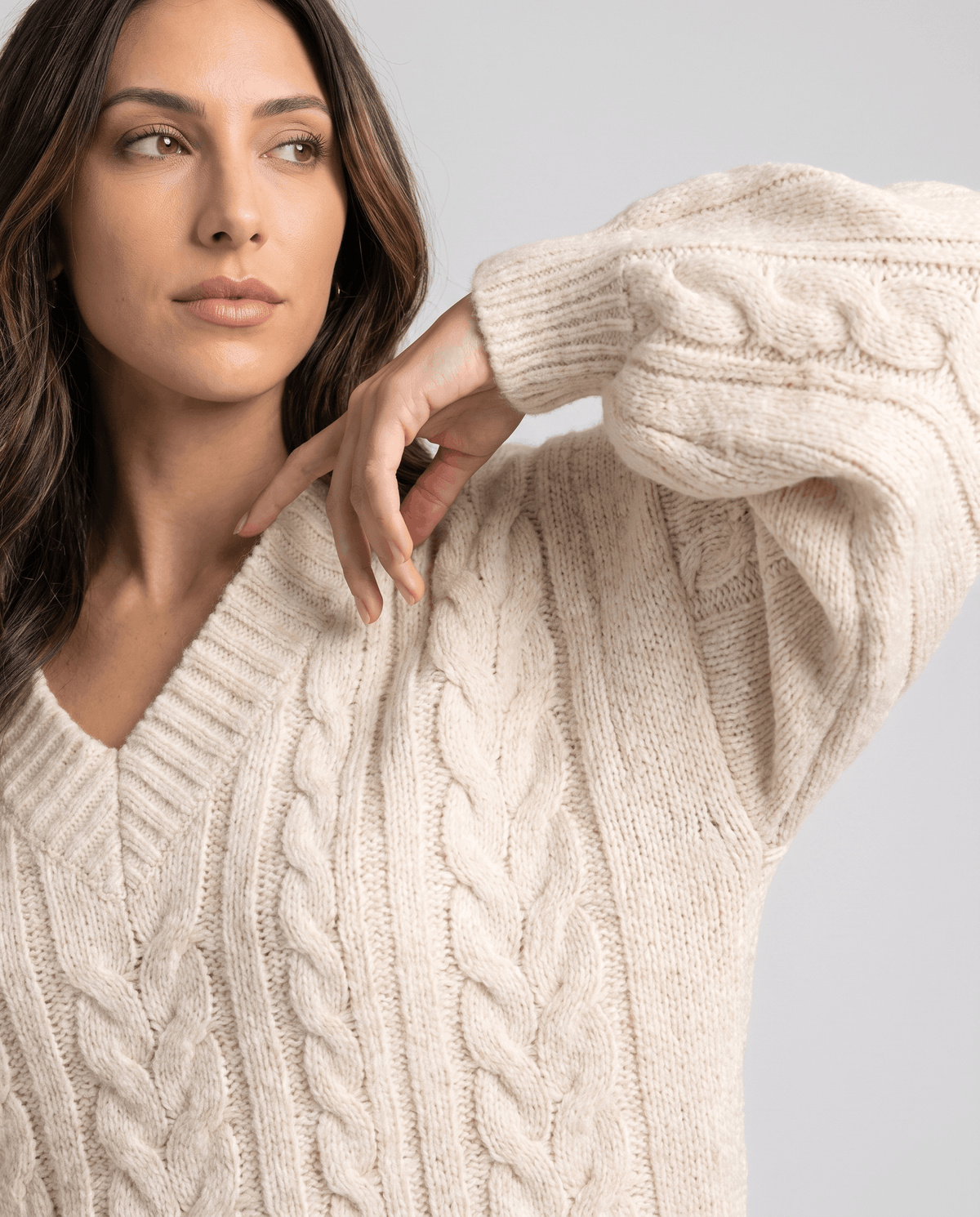 Cream Chunky Cable Knit Sweater worn by a female model, shown in close-up to highlight the chunky cable knit texture, oversized fit, and long sleeves.