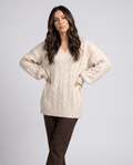 Cream Chunky Cable Knit Sweater – worn by a female model, featuring an oversized fit, textured cable knit pattern, long sleeves, and relaxed silhouette.