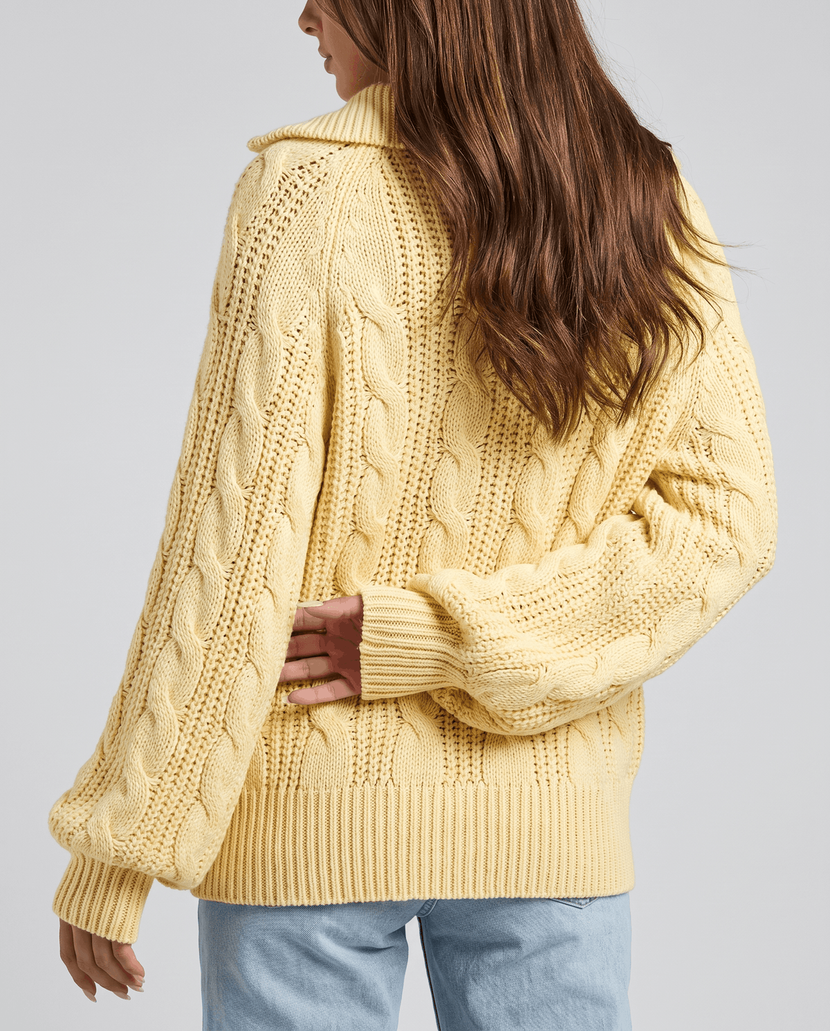 Yellow Chunky Cable Knit Sweater worn by a female model from the back, featuring a stand collar, half-zip front, chunky cable knit texture, long sleeves, and relaxed fit.