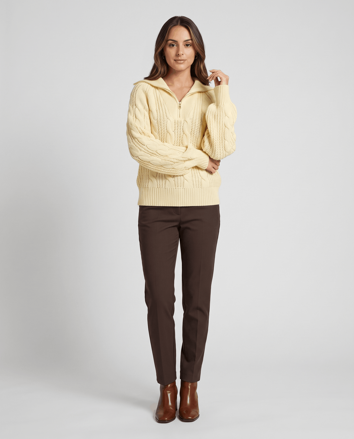 Yellow Chunky Cable Knit Sweater worn by a female model with brown pants and boots, featuring a stand collar, half-zip front, chunky cable knit texture, and relaxed fit.