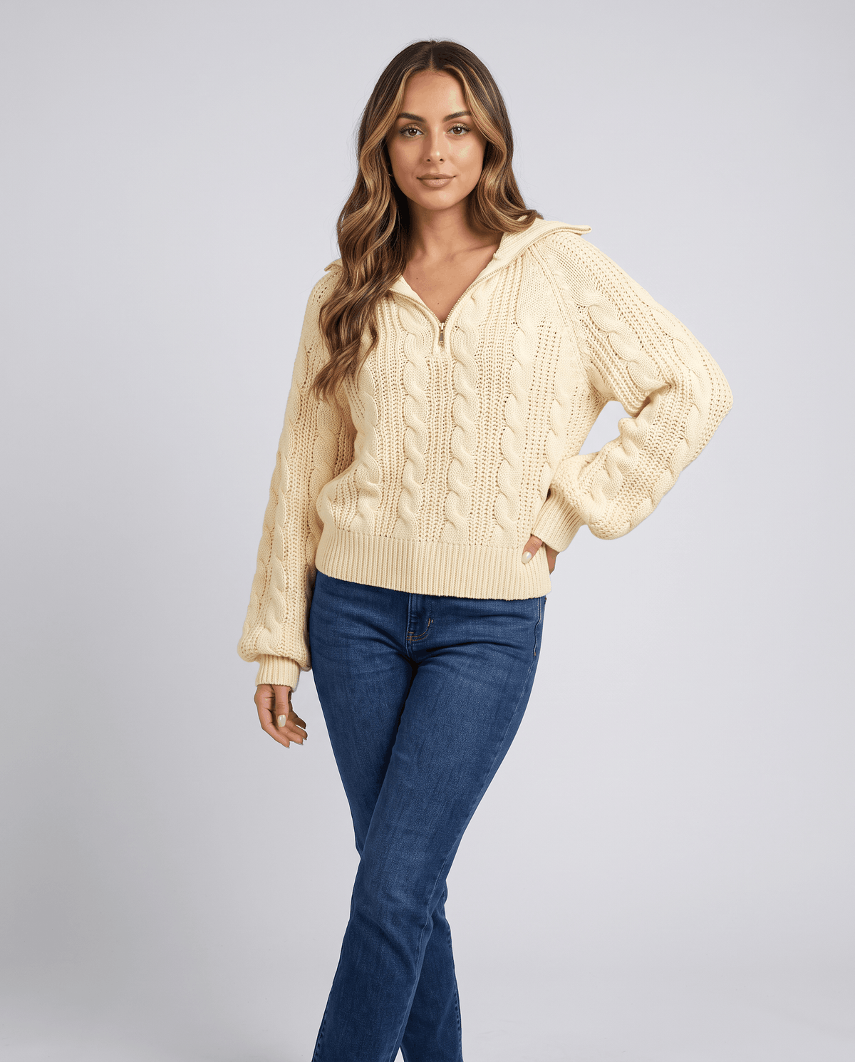Yellow Chunky Cable Knit Sweater worn by a female model with blue jeans, featuring a stand collar, half-zip front, chunky cable knit texture, and relaxed fit.