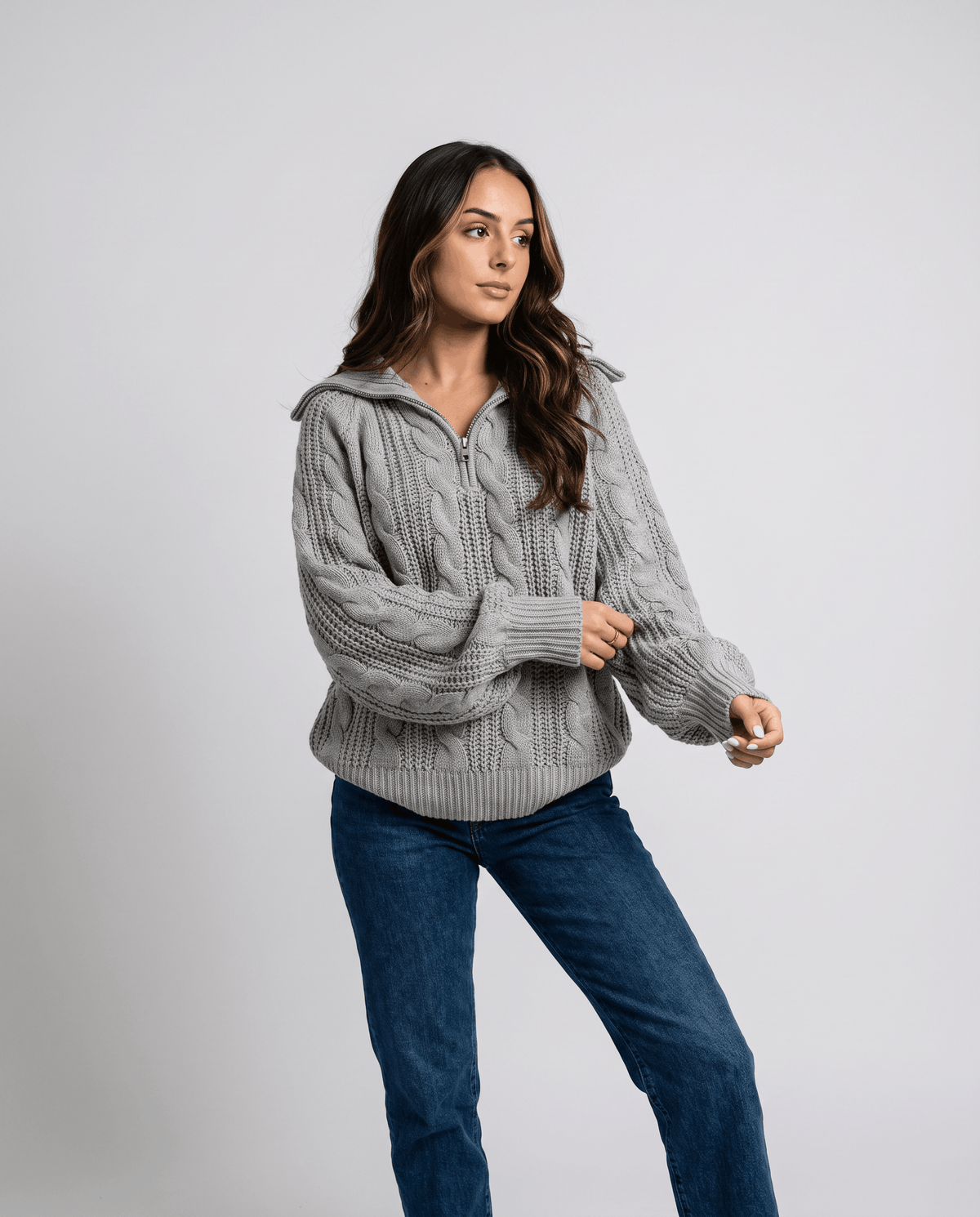 Gray Chunky Cable Knit Sweater  worn by a female model, featuring a stand collar, half-zip front, chunky cable knit texture, long sleeves, and relaxed fit.