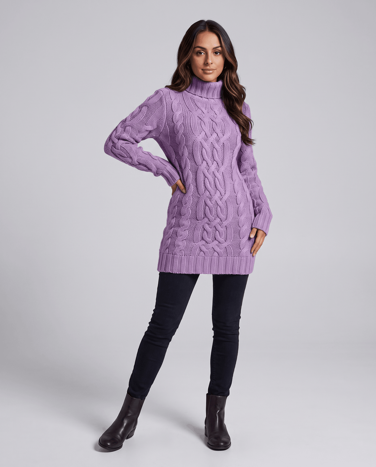 Purple Chunky Cable Knit Sweater worn by a female model with black leggings and boots, featuring a turtleneck, chunky cable knit texture, long sleeves, and ribbed trim.