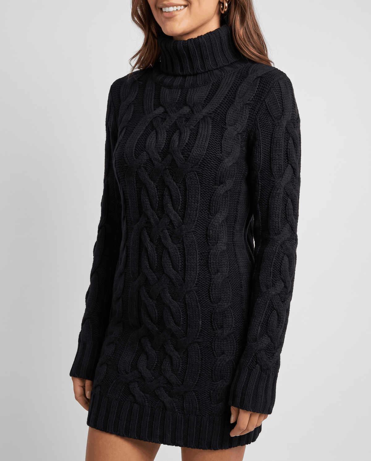Black Chunky Cable Knit Sweater worn by a female model, shown from the front with a turtleneck, chunky cable knit texture, long sleeves, and ribbed trim.
