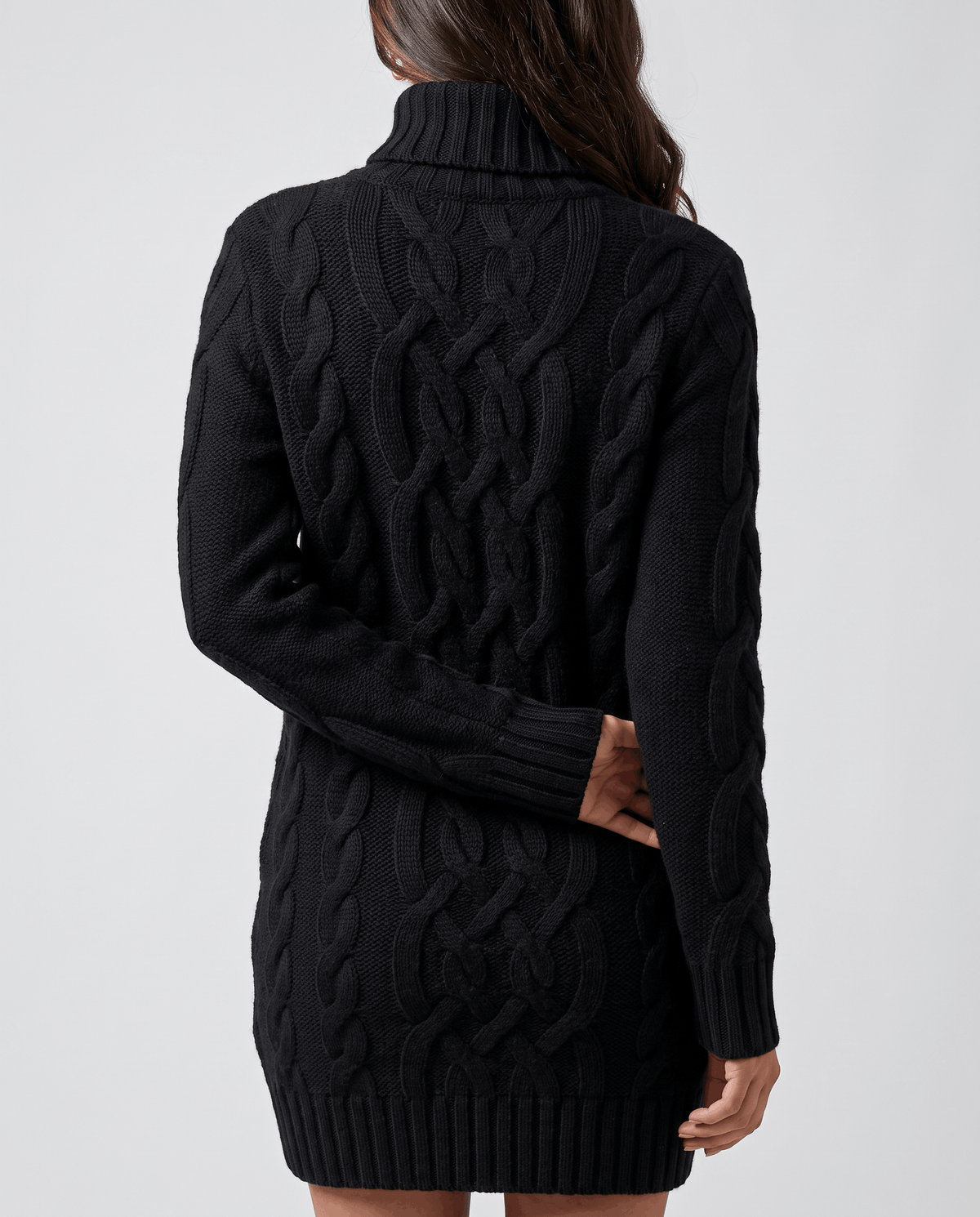 Black Chunky Cable Knit Sweater worn by a female model from the back, highlighting the textured cable knit pattern, turtleneck collar, long sleeves, and ribbed hem.