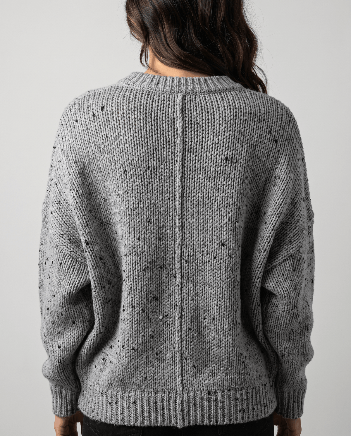 Gray Chunky Knit Sweater worn by a female model from the back, featuring an oversized fit, textured chunky knit pattern, long sleeves, and ribbed hem.