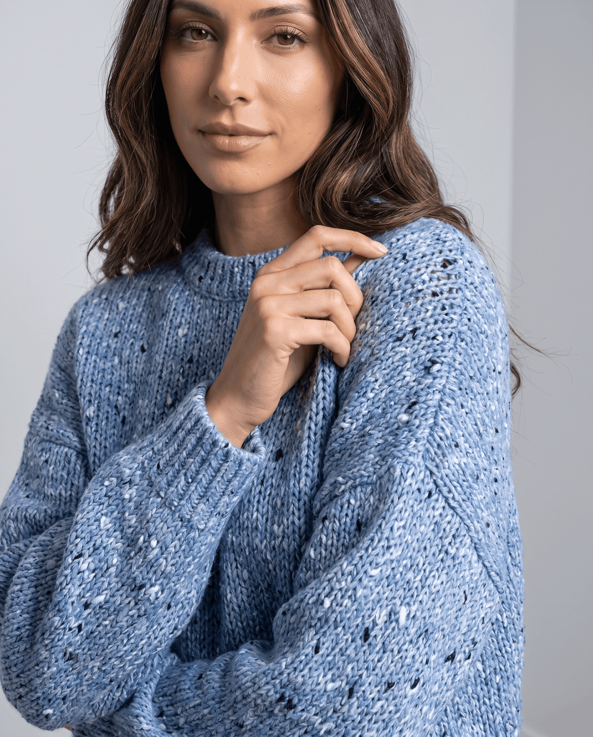 Blue Chunky Knit Sweater worn by a female model, shown in close-up with a textured knit pattern, oversized fit, and long balloon sleeves.