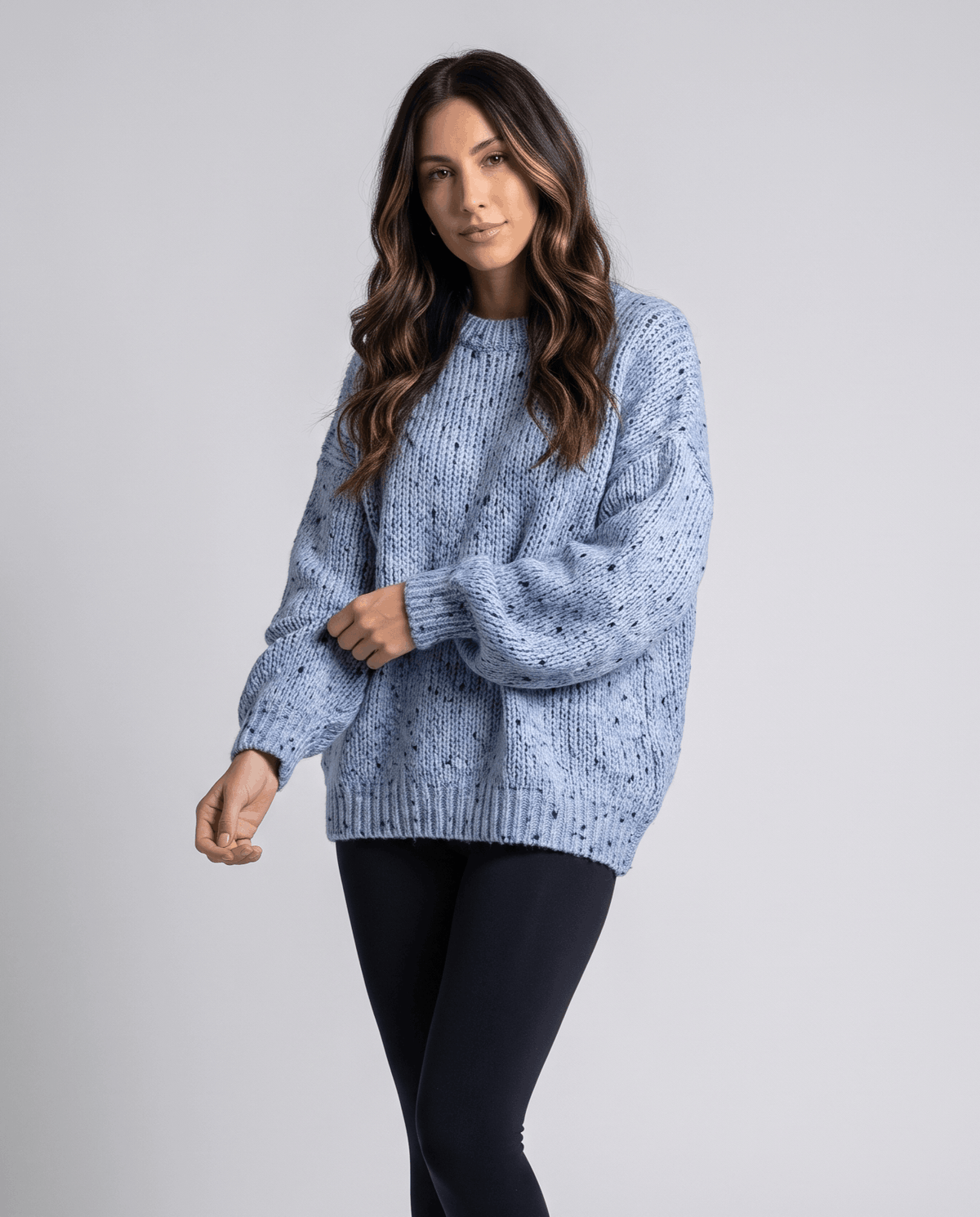 Blue Chunky Knit Sweater worn by a female model, featuring an oversized fit, textured chunky knit pattern, long balloon sleeves, and relaxed silhouette.
