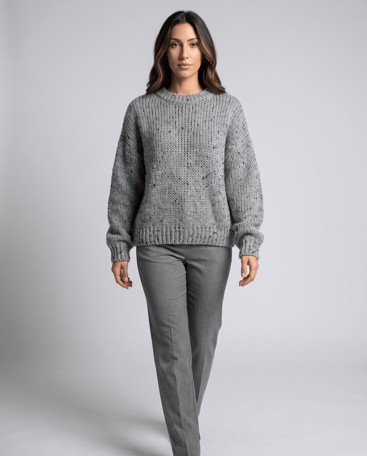Gray Chunky Knit Sweater worn by a female model with gray pants, showcasing the oversized fit, chunky knit texture, long sleeves, and relaxed silhouette.