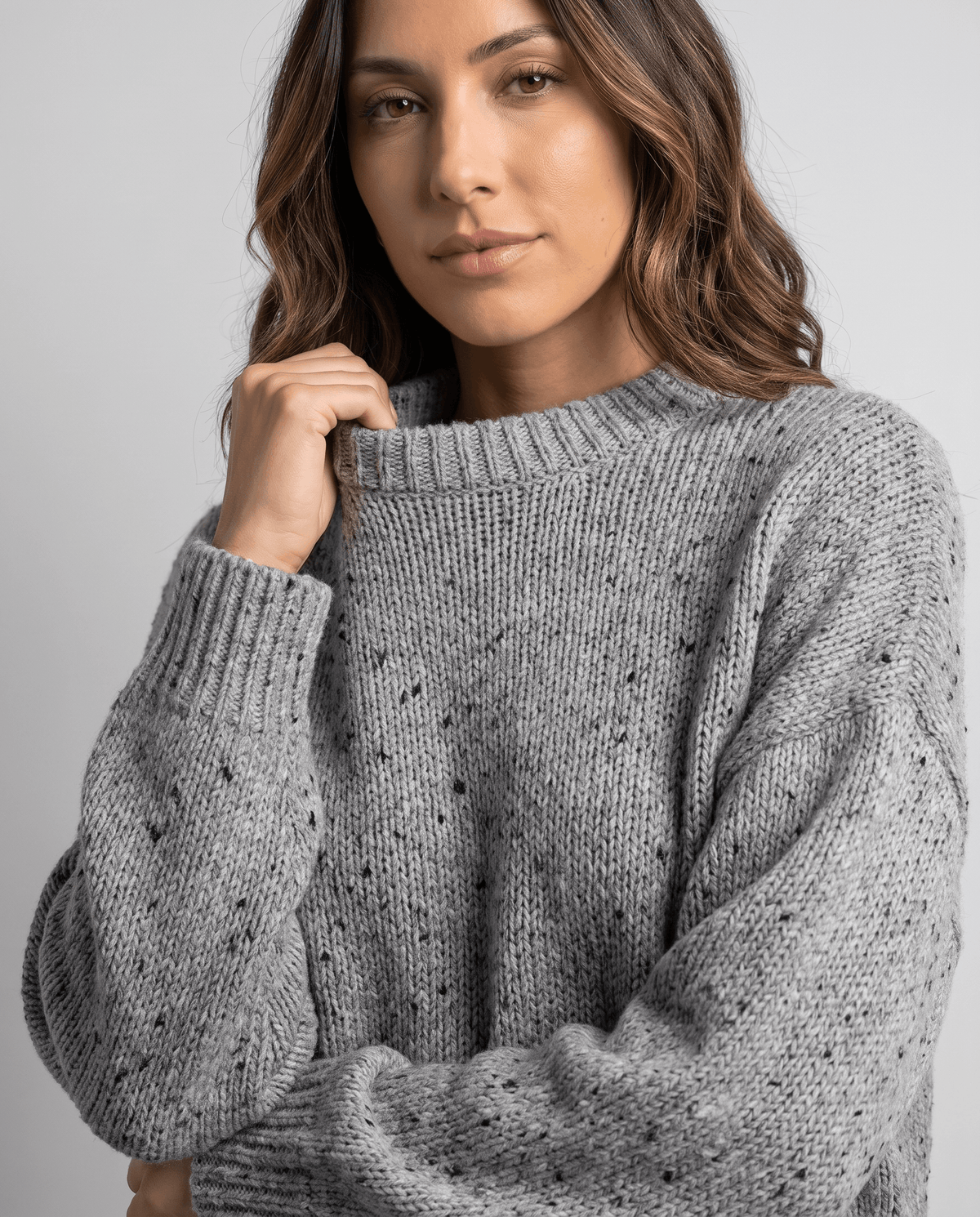 Gray Chunky Knit Sweater worn by a female model, shown in close-up with the textured knit pattern, oversized fit, and long balloon sleeve.