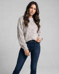 Beige Chunky Knit Sweater worn by a female model, featuring an oversized fit, textured chunky knit pattern, long balloon sleeves, and a relaxed silhouette.