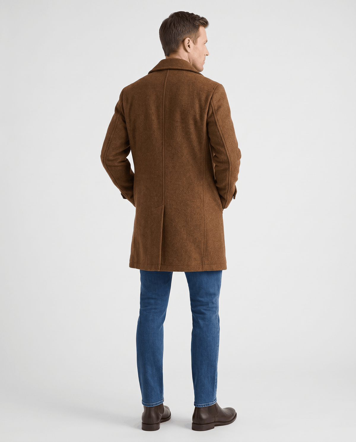 A man wearing a brown classic double-breasted trench coat with a longline fit, shown from the back