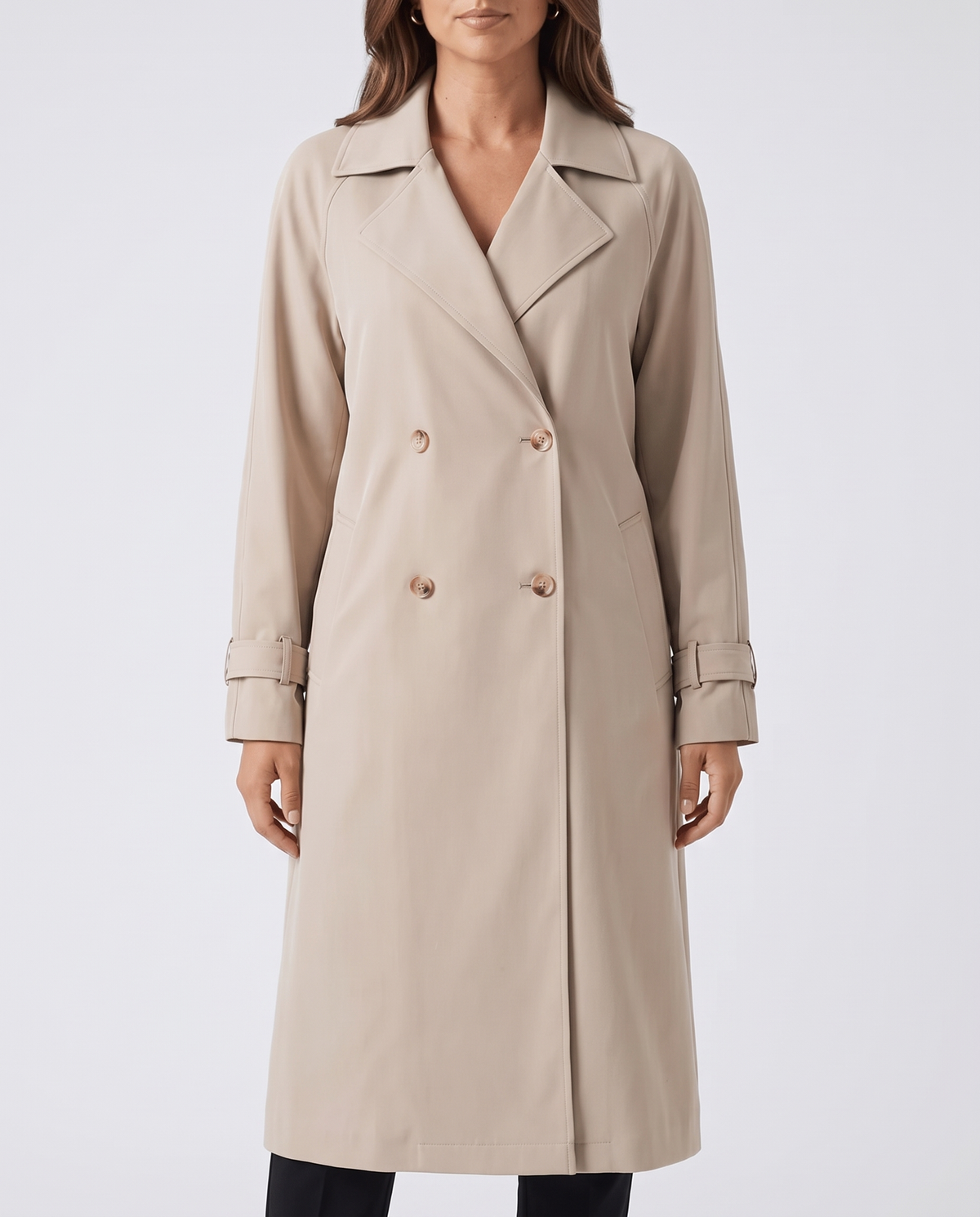 Beige double-breasted trench coat with notched lapels, cuff straps, and side pockets worn by a female model