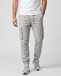 A man wearing light gray cotton cargo jogger pants with a tapered fit and utility pockets