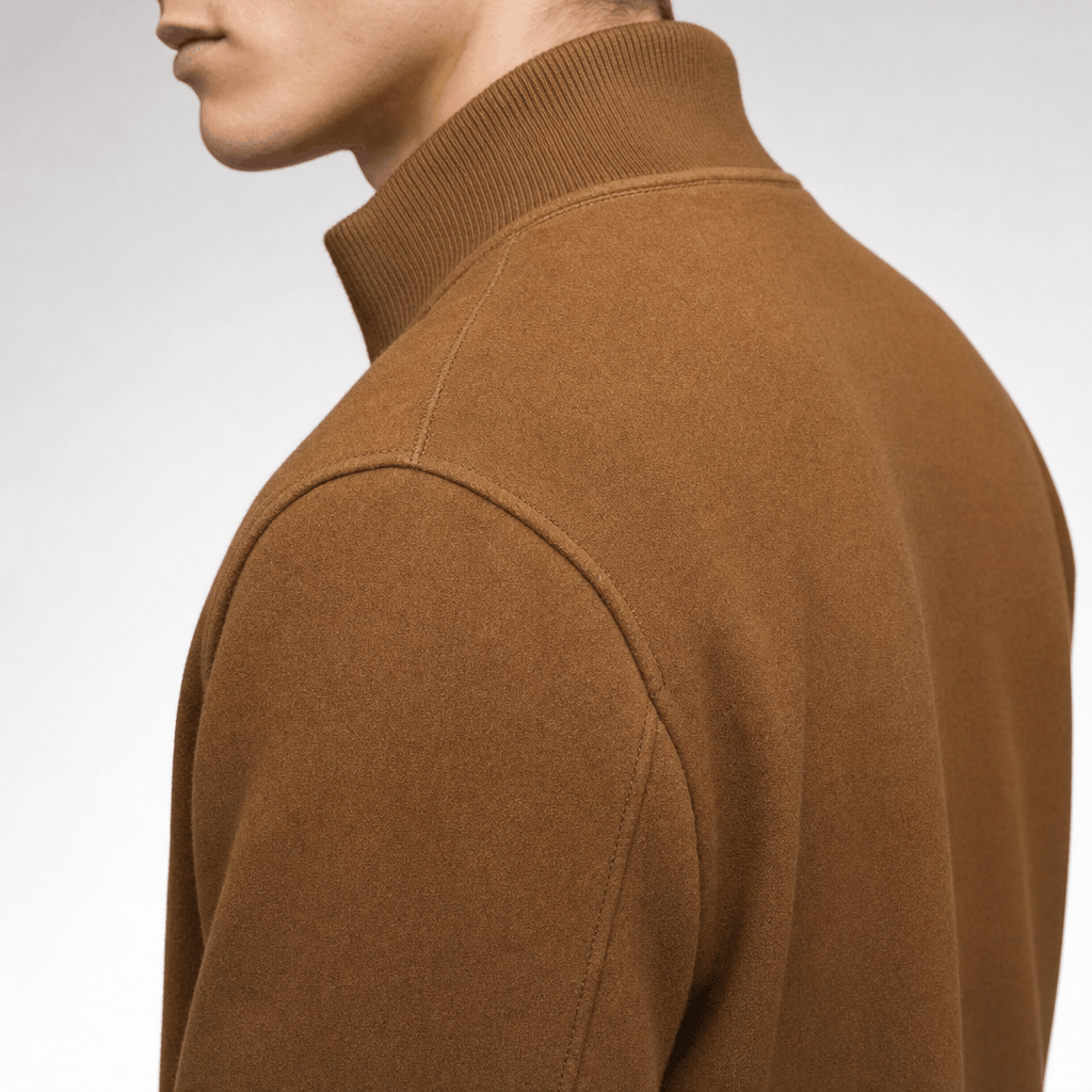Close-up side and back view of the camel brown jacket, showing the raised collar and shoulder.