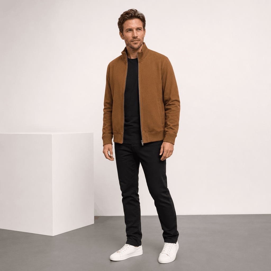 Male model wearing the camel brown zip-up jacket with dark pants and white sneakers.