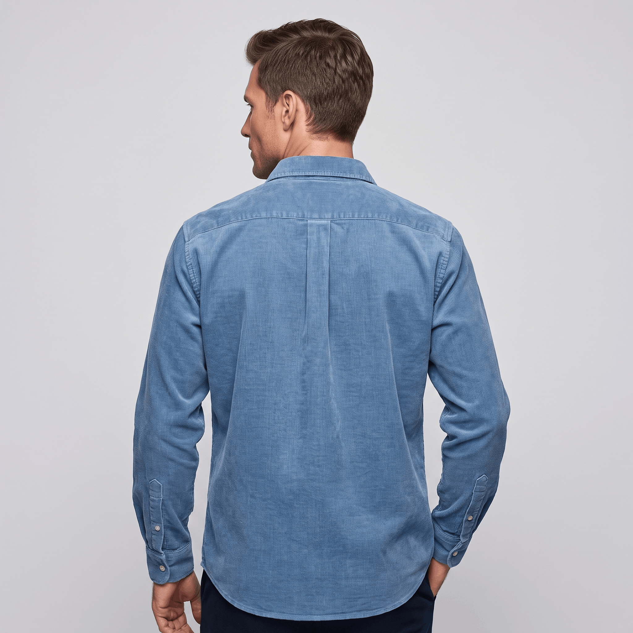 Washed blue fine wale corduroy button-up shirt with a regular fit and curved hem, viewed from the back.