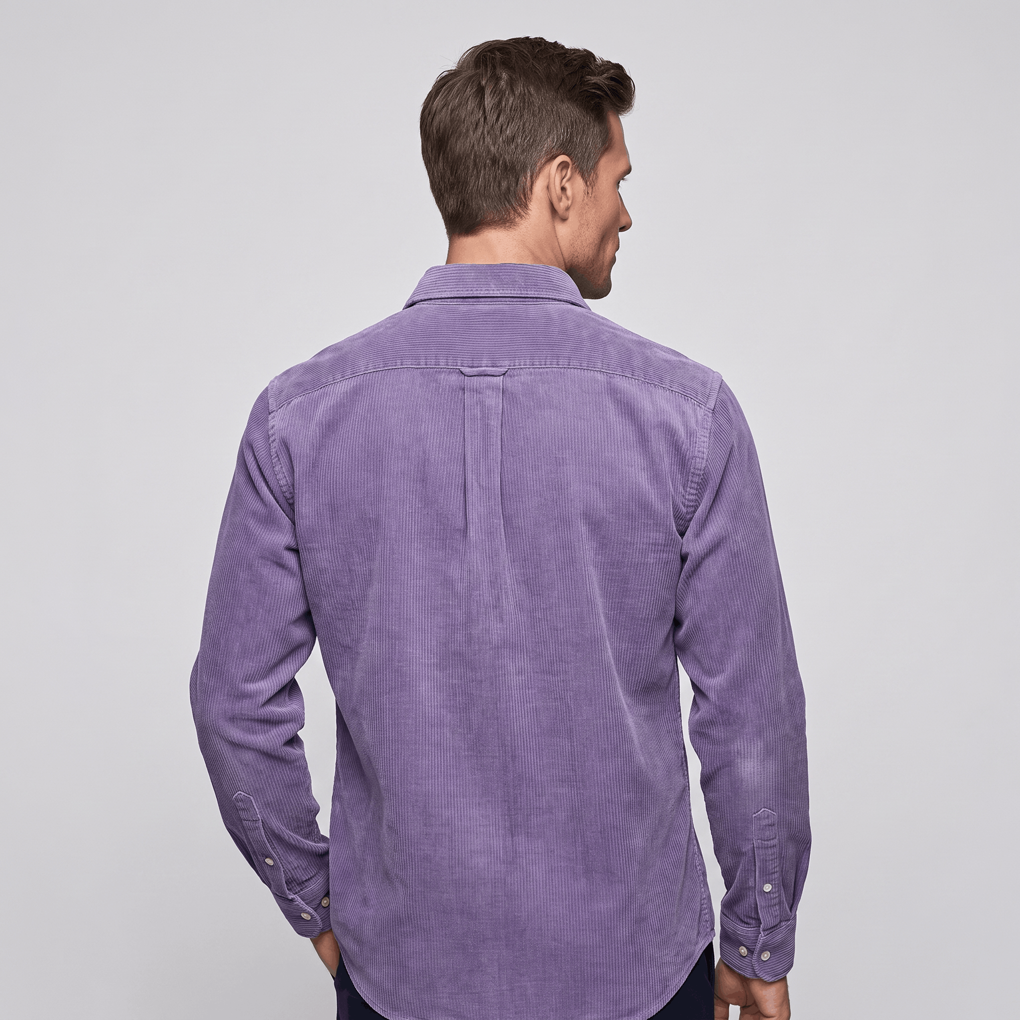 Washed blue fine wale corduroy shirt in a regular fit with a curved hem, shown from the back on a man.