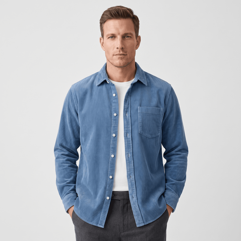 Washed blue fine wale corduroy shirt in a regular fit, worn open over a white tee with a curved hem.