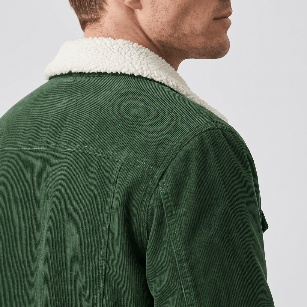 Forest green corduroy jacket featuring a plush white sherpa-lined collar and structured shoulder yoke.