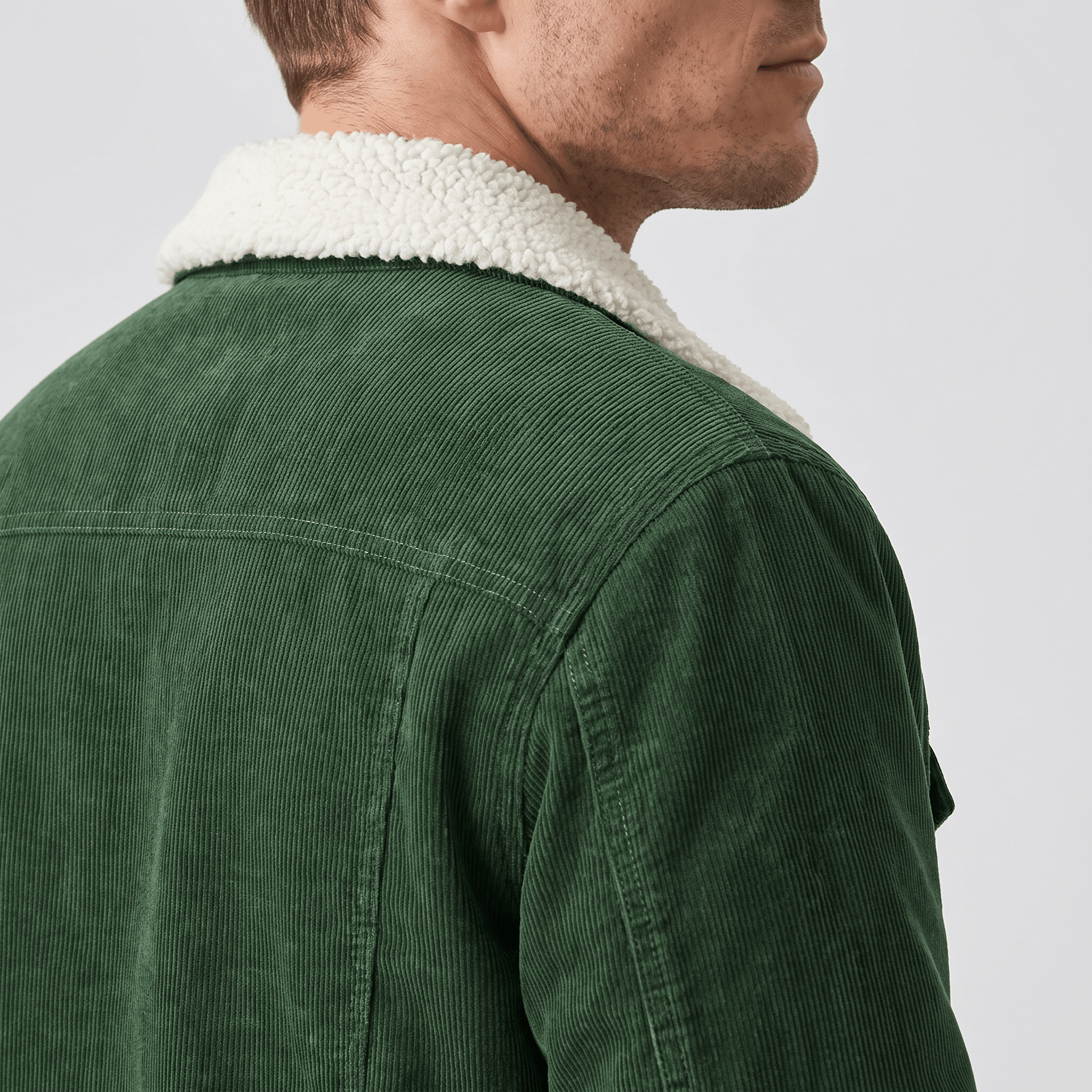 Forest green corduroy jacket featuring a plush white sherpa-lined collar and structured shoulder yoke.