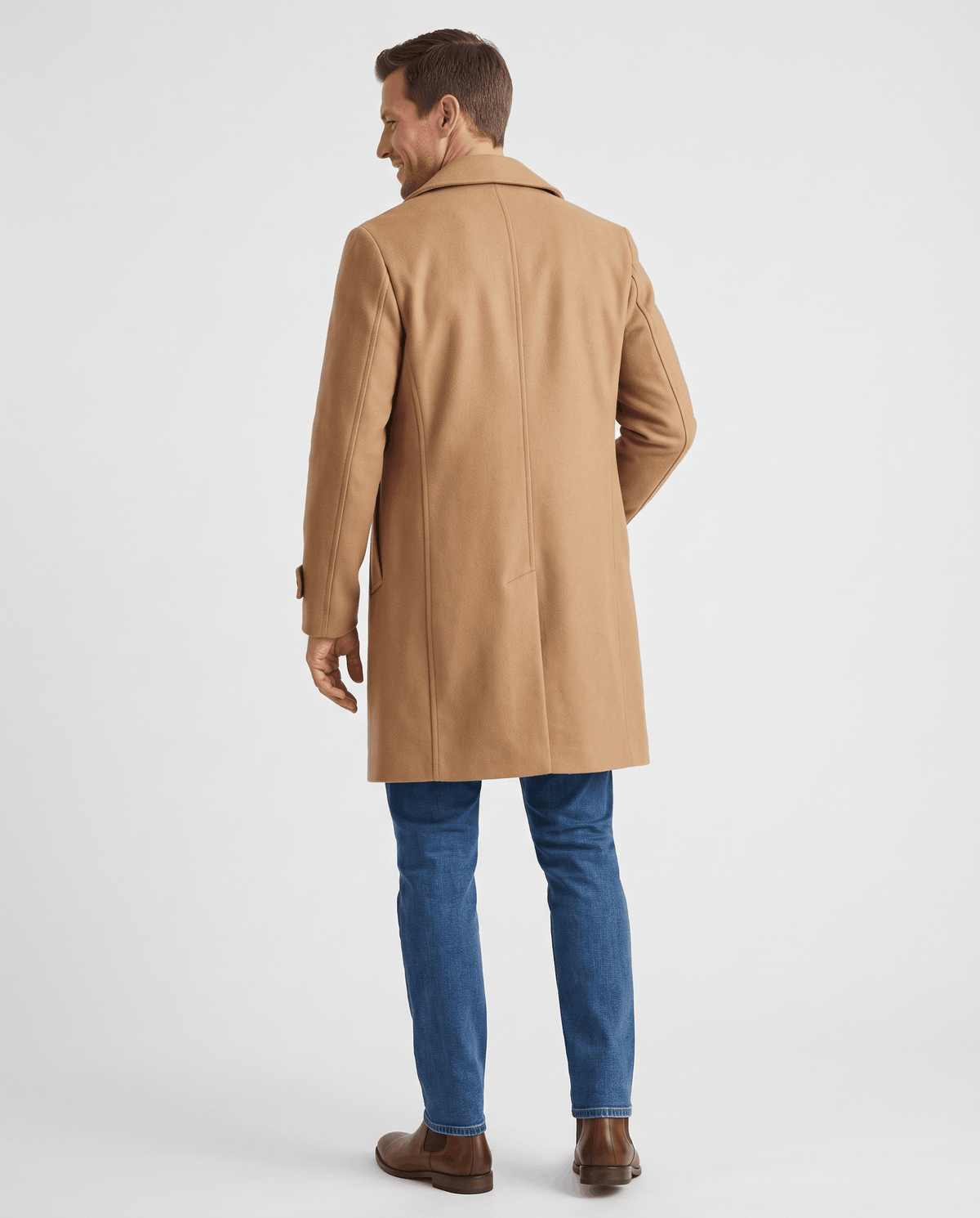 A man wearing a camel double-breasted trench coat with a longline fit and structured shoulders, back view
