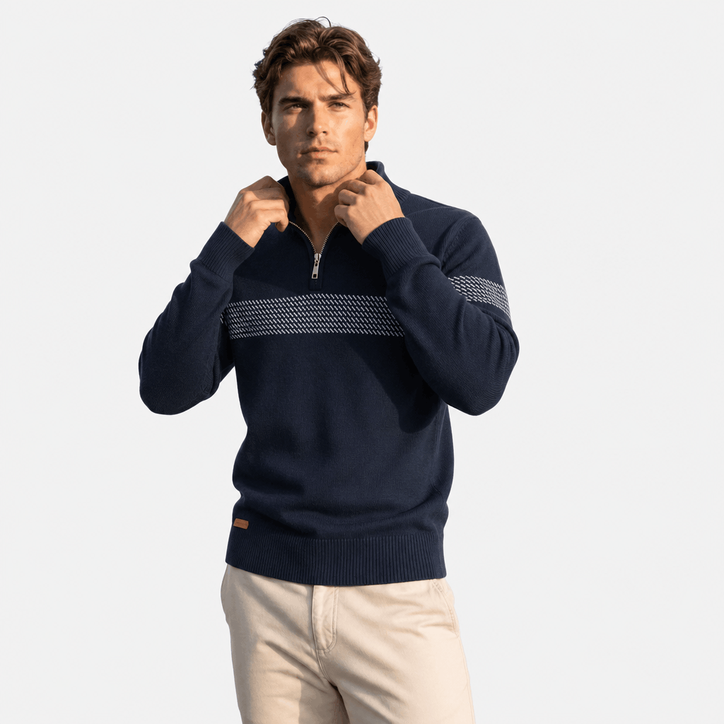 Close-up of a male model adjusting the collar zipper on the dark navy textured quarter-zip sweater.