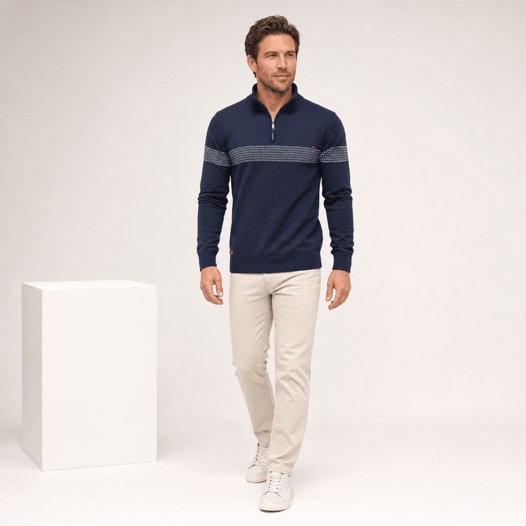 Full-body view of a male model wearing the navy quarter-zip sweater with beige trousers.