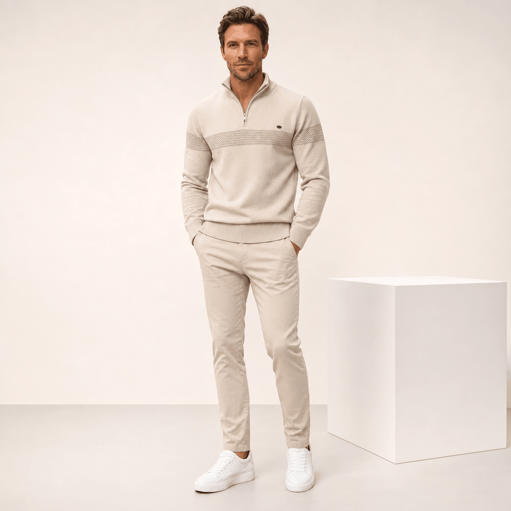 Full-body view of a male model wearing the beige quarter-zip sweater and matching trousers.