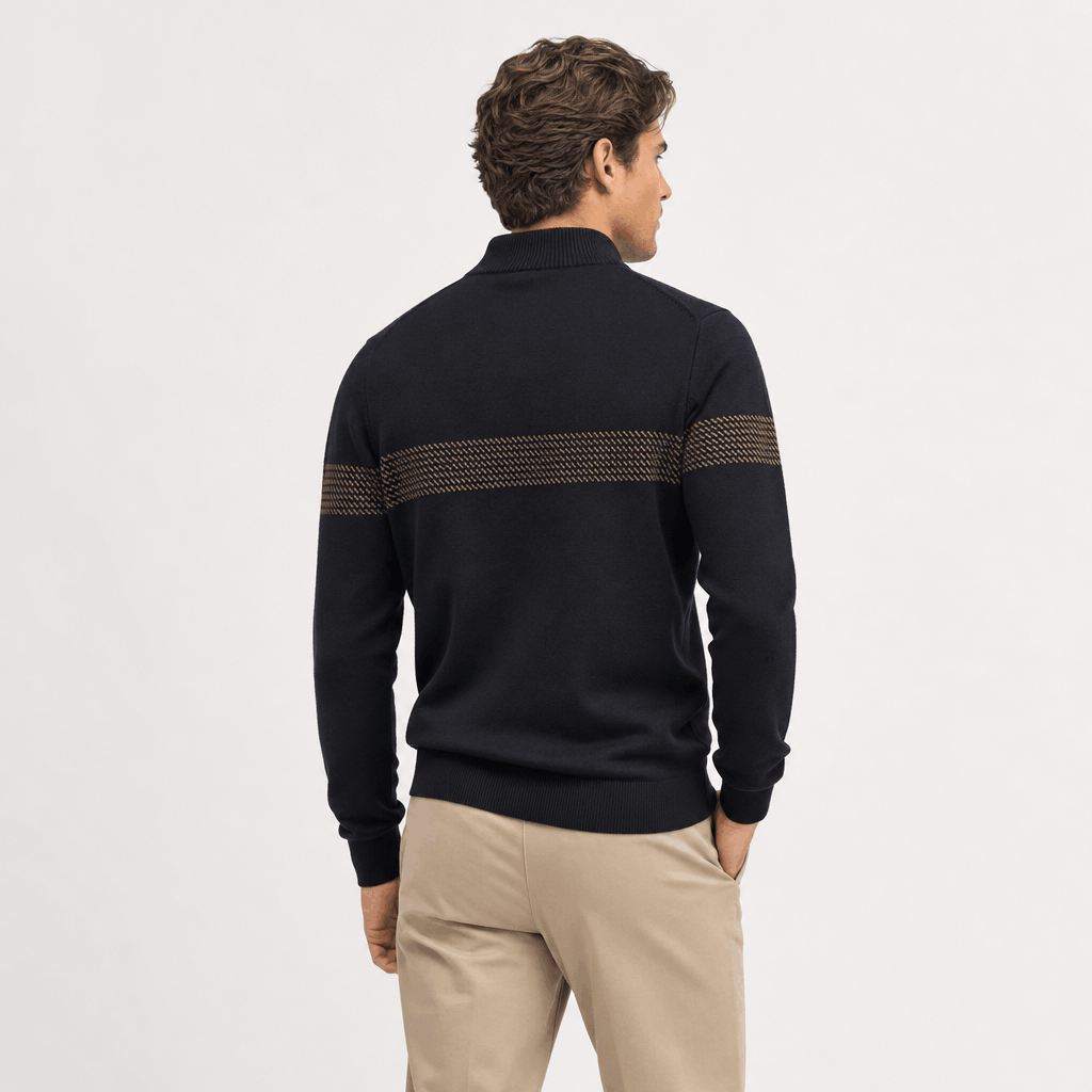 Back view of a male model wearing the black quarter-zip sweater and beige trousers.