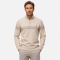 Male model wearing a beige quarter-zip sweater with a subtle textured horizontal stripe across the chest, paired with matching cream trousers, front view.