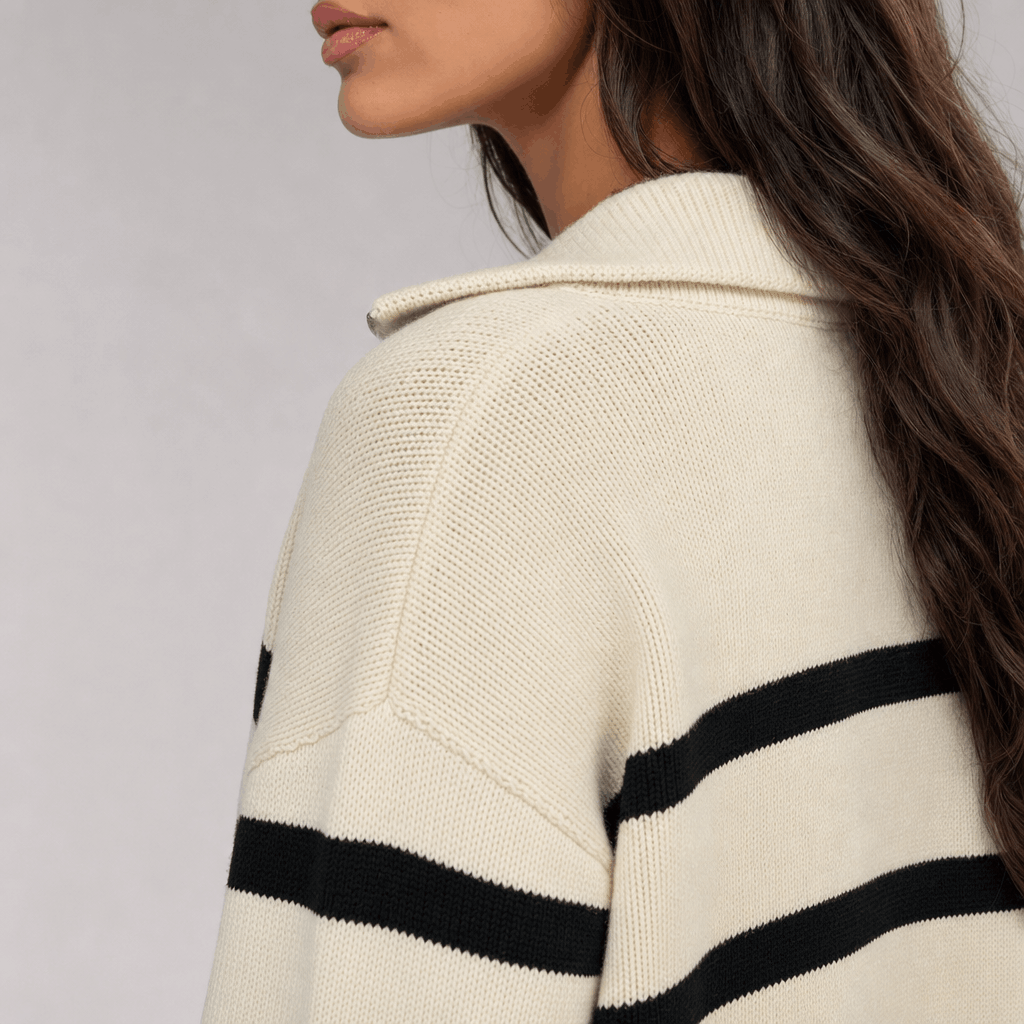 Back and side close-up of the cream striped sweater, highlighting the raised collar and stripe pattern.